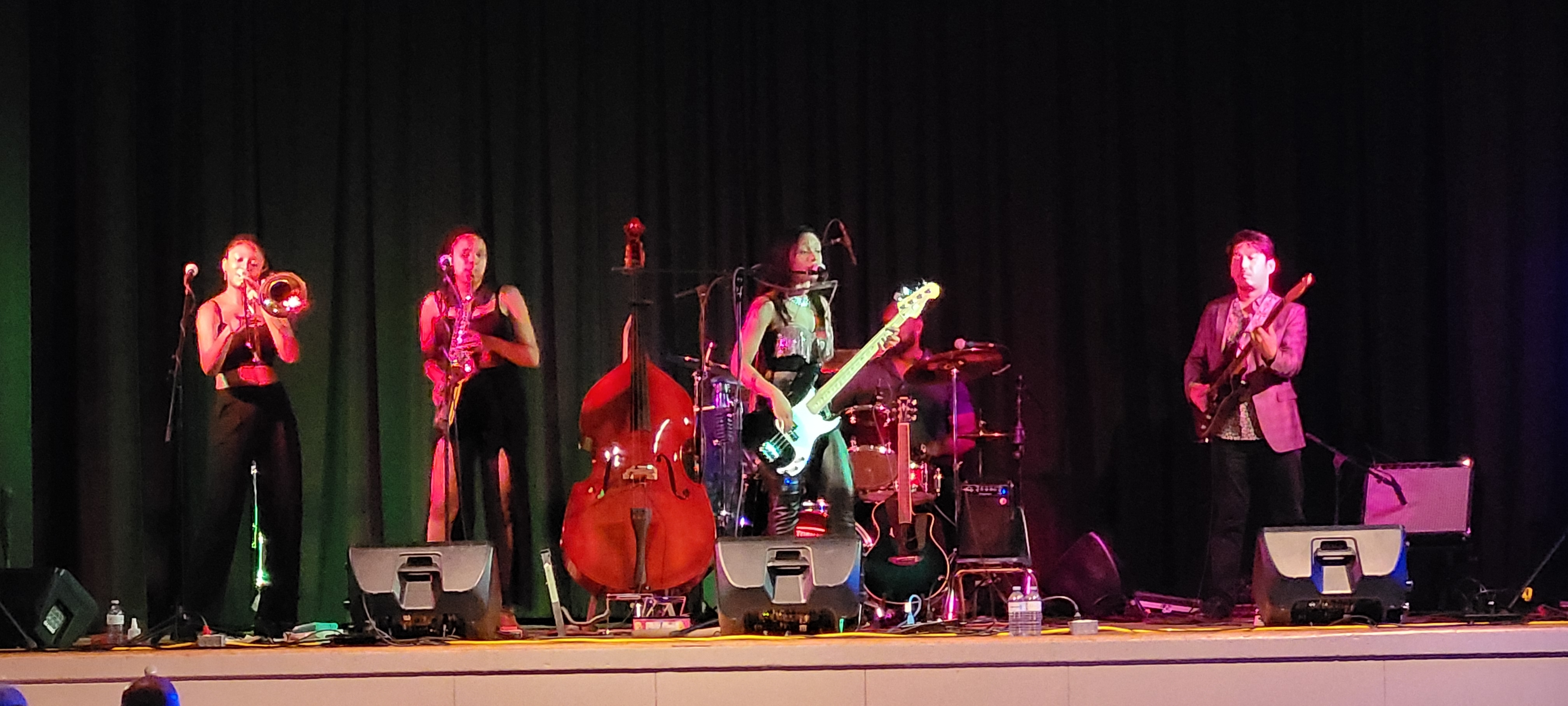Angelique Francis performing live with a full band on theater stage